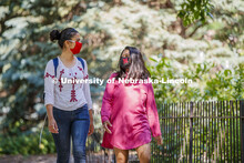 Asmita Jayswal, junior in computer science, and Esha Mishra, graduate student in physics, walk along