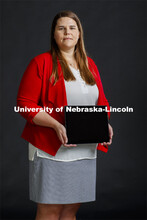Grace Panther, assistant professor in civil engineering, holds a tablet with her research on teamwor