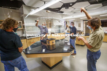 Nebraska's (from left) Mark Thompson, Keith Placek, Jody Redepenning and Pat Pribil lift an acrylic 