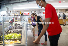 Students selecting food and being served by UNL Dining Staff. Photo shoot of students wearing masks 