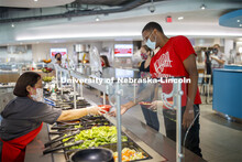 Students selecting food and being served by UNL Dining Staff. Photo shoot of students wearing masks 