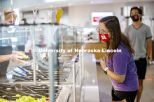 Students selecting food and being served by UNL Dining Staff. Photo shoot of students wearing masks 