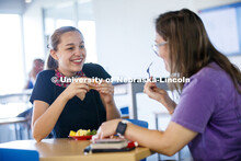 Students eating in the Willa Cather Dining Center. Photo shoot of students wearing masks and practic