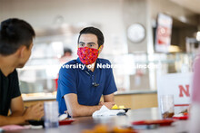 Young men having lunch together in the Willa Cather Dining Center. Photo shoot of students wearing m