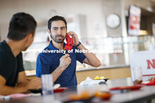 Young men having lunch together in the Willa Cather Dining Center. Photo shoot of students wearing m