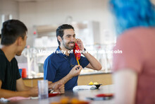 Young men having lunch together in the Willa Cather Dining Center. Photo shoot of students wearing m