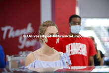 Students standing in line at the Willa Cather Dining Center wearing masks. Photo shoot of students w