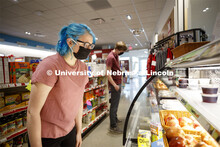 Students shopping in the convenience store. Photo shoot of students wearing masks and practicing soc