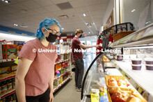 Students shopping in the convenience store. Photo shoot of students wearing masks and practicing soc