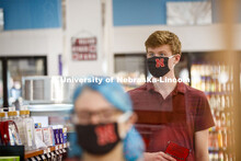 Students shopping in the convenience store. Photo shoot of students wearing masks and practicing soc