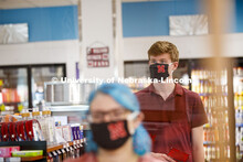 Students shopping in the convenience store. Photo shoot of students wearing masks and practicing soc