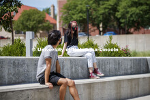 Students socialize outside the Willa Cather Dining Complex. Photo shoot of students wearing masks an