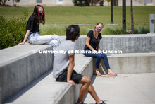 Students socialize outside the Willa Cather Dining Complex. Photo shoot of students wearing masks an