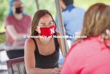 Students socialize on the patio outside the Willa Cather Dining Complex. Photo shoot of students wea