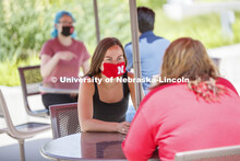 Students socialize on the patio outside the Willa Cather Dining Complex. Photo shoot of students wea