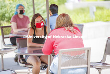 Students socialize on the patio outside the Willa Cather Dining Complex. Photo shoot of students wea