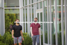 Students socialize outside the Willa Cather Dining Complex. Photo shoot of students wearing masks an