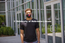 Hunter Johnson, a Junior in finance from Omaha wears a Husker mask. Photo shoot of students wearing 
