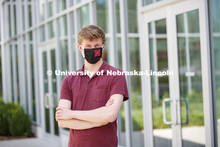 Joe Levey, senior in biology from Sturgis, SD wears a Husker mask. Photo shoot of students wearing m