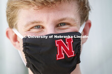 Joe Levey, senior in biology from Sturgis, SD wears a Husker mask. Photo shoot of students wearing m