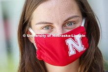 Anna Sambol, a Senior in Nutritional Science and Dietetics wears a Husker mask. Photo shoot of stude