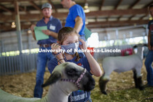 Bailey Faltys, 10 of Columbus, Nebraska, puts on her mask before participating in the Registered Bre