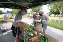 Vendors selling their produce at the Fallbrook Farmers Market in northwest Lincoln, Nebraska. July 2