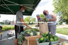 Vendors selling their produce at the Fallbrook Farmers Market in northwest Lincoln, Nebraska. July 2