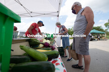 Vendors selling their produce at the Fallbrook Farmers Market in northwest Lincoln, Nebraska. July 2