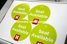 Marking classroom seats in Louise Pound Hall as part of preparing the campus for Forward to Fall. A 