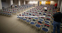 The marking crew works through the Louise Pound Hall lecture hall marking available and unavailable 