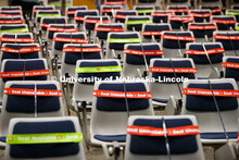 The marking crew works through the Louise Pound Hall lecture hall marking available and unavailable 