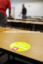 A seat-available sticker marking in the Temple building. Crews mark classroom seats as part of prepa
