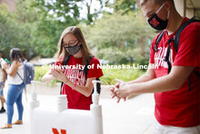 Photo shoot of students display mask wearing and hand sanitizing. Students at a hand sanitizing stat