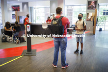 Photo shoot of students on city campus display mask wearing, social distancing. Two young men wearin
