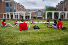 Photo shoot of students on city campus display mask wearing and social distancing. Students lounge o