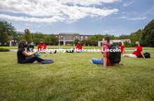 Photo shoot of students on city campus display mask wearing and social distancing. Students hang out