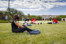 Photo shoot of students on city campus display mask wearing and social distancing. Students hang out