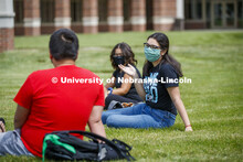 Photo shoot of students on city campus display mask wearing and social distancing. Students hang out
