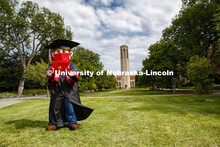 Herbie Husker has a protective mask on while he poses in front of the Mueller Bell tower while weari