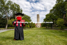 Herbie Husker has a protective mask on while he poses in front of the Mueller Bell tower while weari