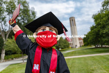 Herbie Husker has a protective mask on while he poses in front of the Mueller Bell tower while weari