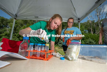 Natalie Keller and Remi Christensen prepare corn roots for cutting then washing. They will be taking