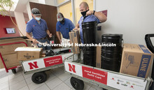 Nick Glass, James Soukup and Travis Smith of Building Systems Maintenance are distributing sanitizer