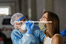Photo shoot of UNL On-Campus COVID Testing Site. A medical technician completes a nasal swab test at
