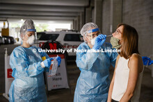 Photo shoot of UNL On-Campus COVID Testing Site. A medical technician completes a nasal swab test at