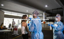 Photo shoot of UNL On-Campus COVID Testing Site. A medical technician completes a nasal swab test at