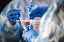 Photo shoot of UNL On-Campus COVID Testing Site. A medical technician completes a nasal swab test at