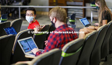 Masked students in an Anderson Hall Lecture Hall are seated for social distancing. Photo shoot of st
