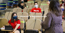 Masked students in an Anderson Hall Lecture Hall are seated for social distancing. Photo shoot of st